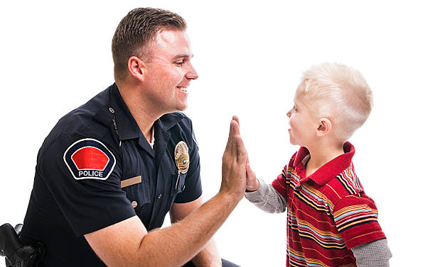Police officer high fives child